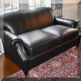 F06. Kravet Furniture leather loveseat. 34”h x 61”w x 38”d 